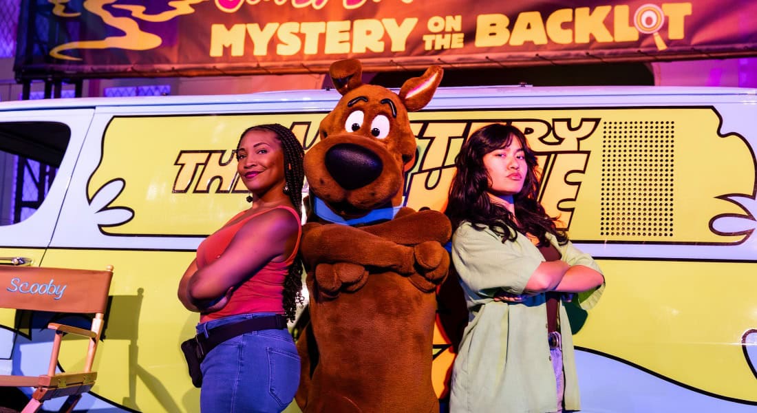 Fans pose with Scooby-Doo in front of the famous Mystery Machine.