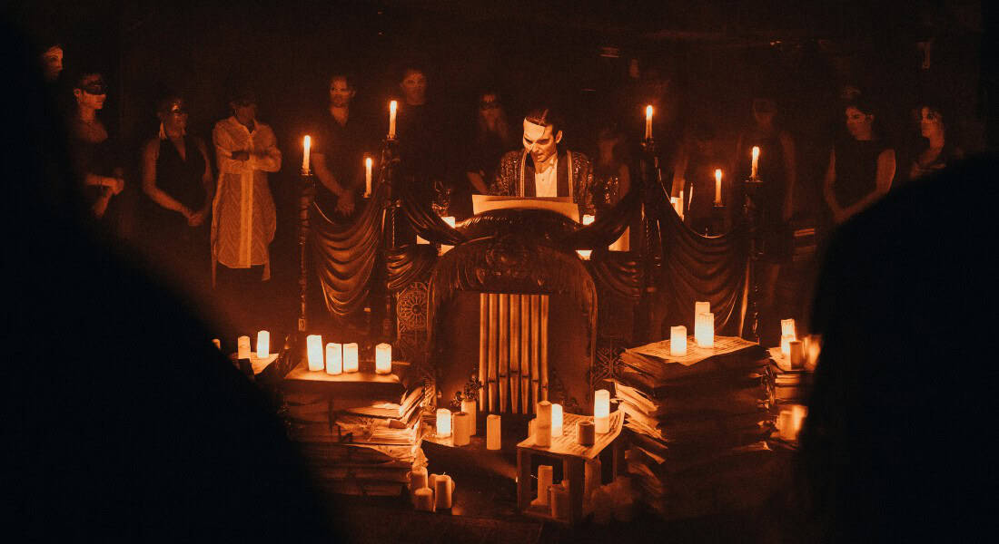 Masquerade scene. Audience is part of the "cast". Photo by Andy Henderson