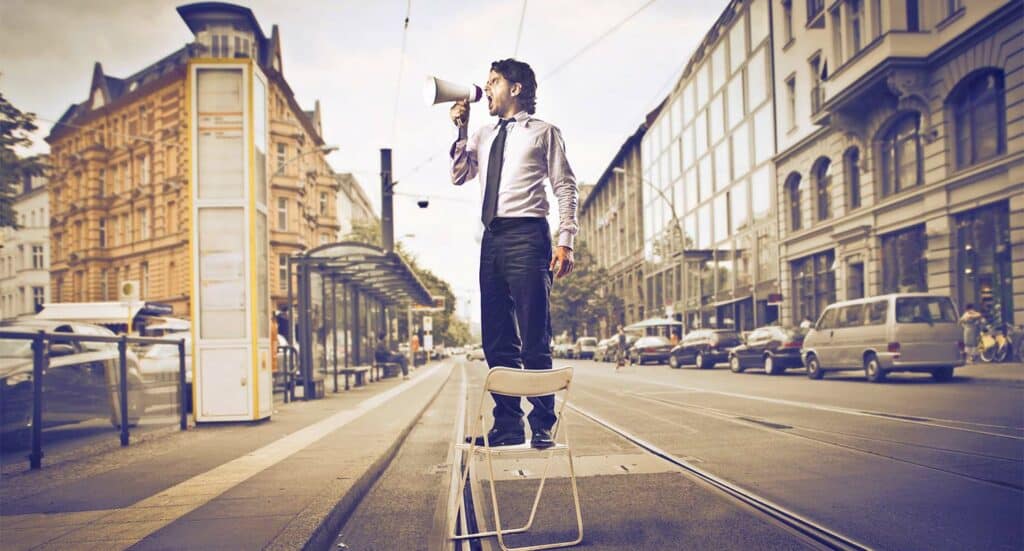 Salesman with Bullhorn in road - Marketing Medicare supplement insurance