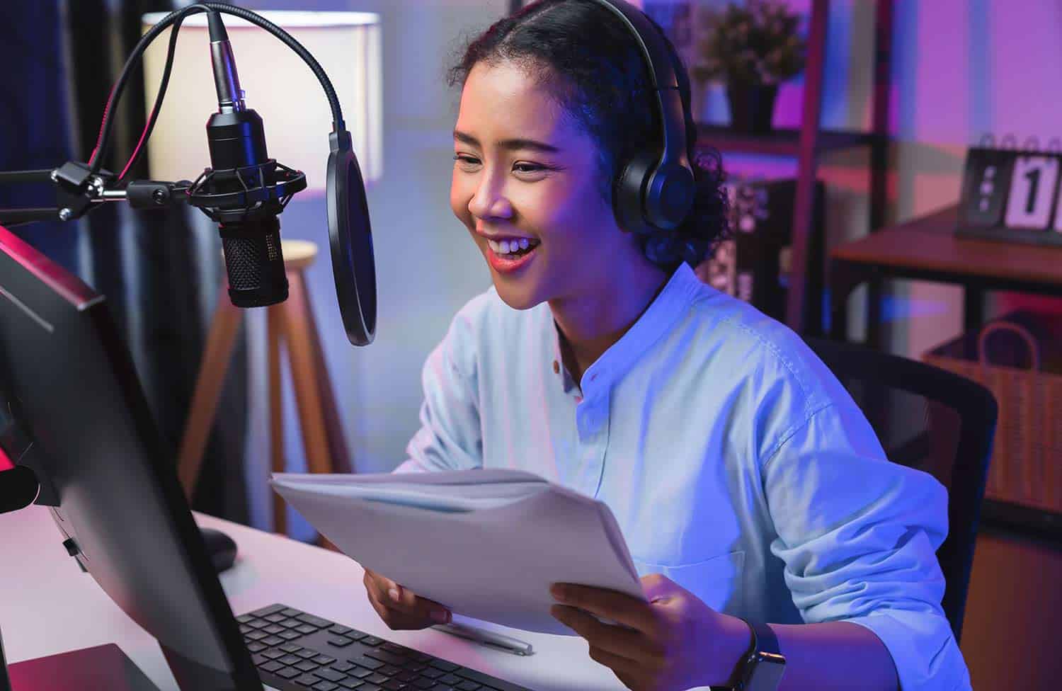 Woman recording a podcast at her computer