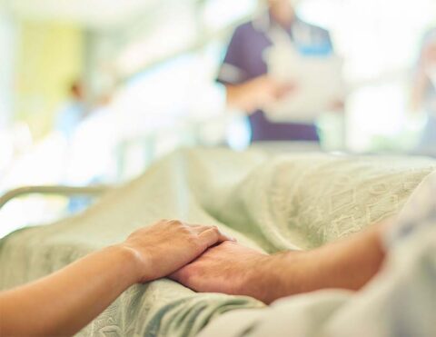 Patient being consoled by Family member at the bed