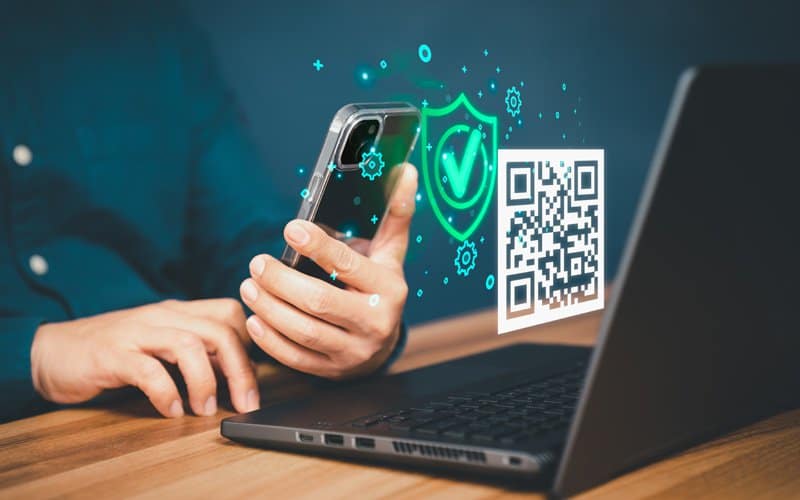 A person scanning QR code at computer