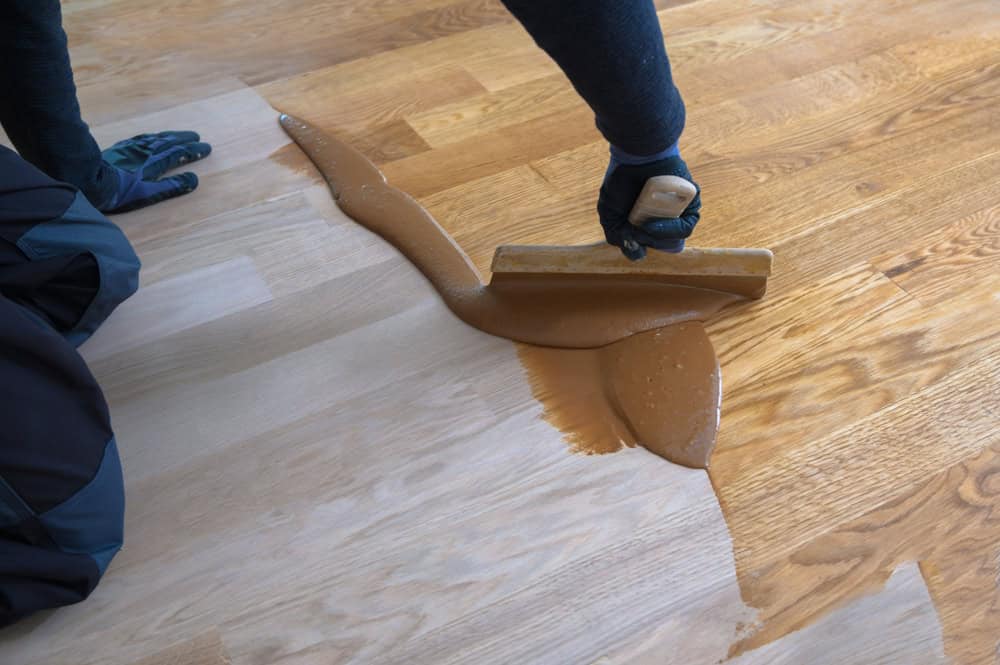 Worker,With,Gloves,Grouting,Wooden,Parquet,,Phase,After,Sanding.,Varnishing