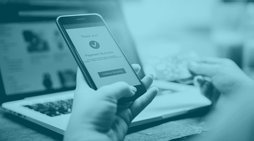 Hand holding cell phone with successful online purchase message. Related to Issuer Declines of rejected purchases.