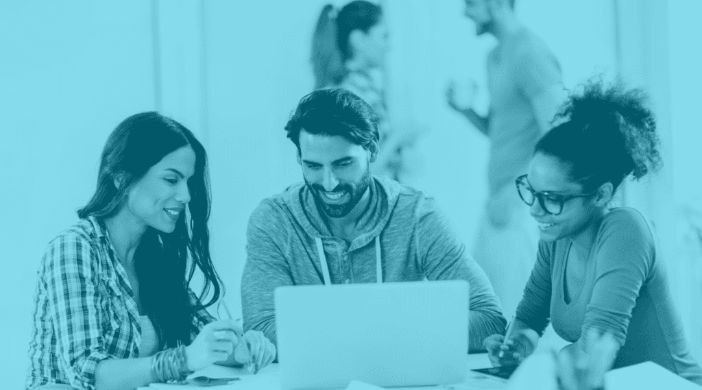 Man and two women sit together in front of laptop. They are happy with seamless platform integration for their payment processing.