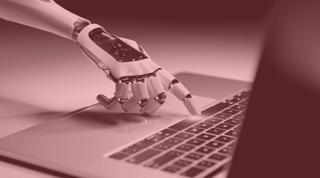AI in payment processing depicted by robot hand pressing on laptop keyboard
