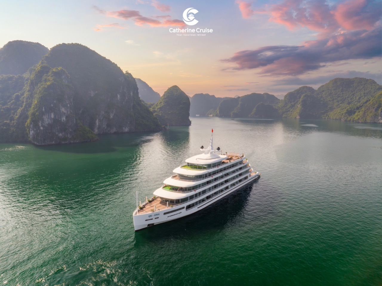 Luxurious yacht cruising Halong Bay, Vietnam at sunset for an unforgettable vacation.