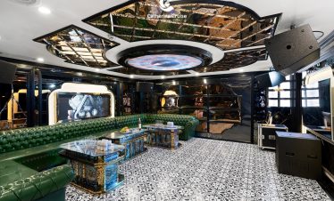 Luxurious cruise lounge with modern decor and sound system for private parties and events.