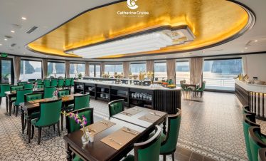 Elegant cruise restaurant with ocean views, luxurious decor, and fine dining setup.