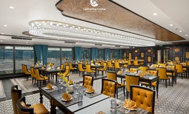 Luxurious restaurant interior with elegant yellow chairs and stylish table settings, perfect for fine dining.