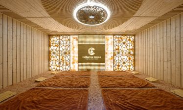 Relaxing spa room with warm lighting and wooden decor at ViettrendTour’s luxury retreat.