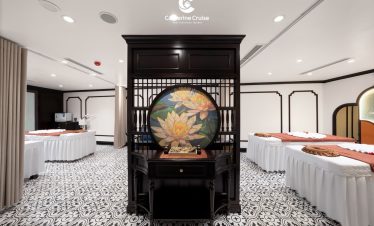 Elegant spa massage room with traditional Asian decor and lotus artwork, perfect for relaxation.