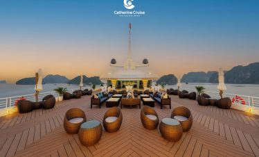Luxurious yacht deck with outdoor seating and scenic ocean views at sunset, premium cruise experience.