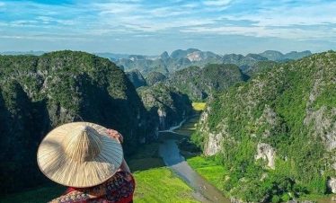 Scenic view of lush green mountains and river in Sapa, perfect for trekking and nature exploration.
