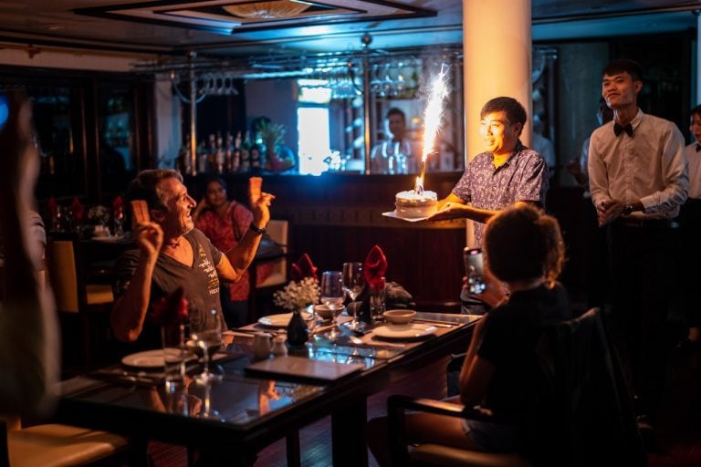 Surprised by cake, candles, and a cheerful crew—make your special day unforgettable with new friends at sea.