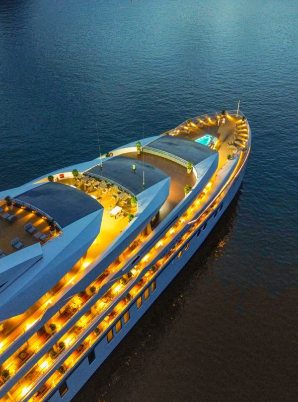 Luxury cruise yacht at sunset, Vietnam travel, scenic boat tour for vacation.