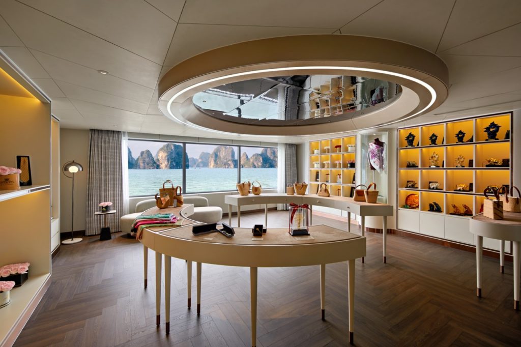 Elegant boutique shop with sea view, showcasing luxury handbags and accessories, bright interior, modern design, coastal scenery.