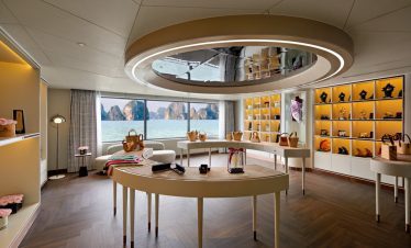 Elegant boutique shop with sea view, showcasing luxury handbags and accessories, bright interior, modern design, coastal scenery.