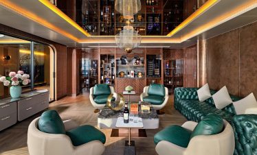 Luxurious modern lounge with stylish green and white seating, wooden accents, and elegant lighting.