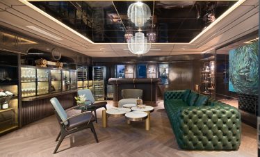 Luxurious Modern Lounge with Green Leather Chesterfield Sofa and Elegant Lighting.