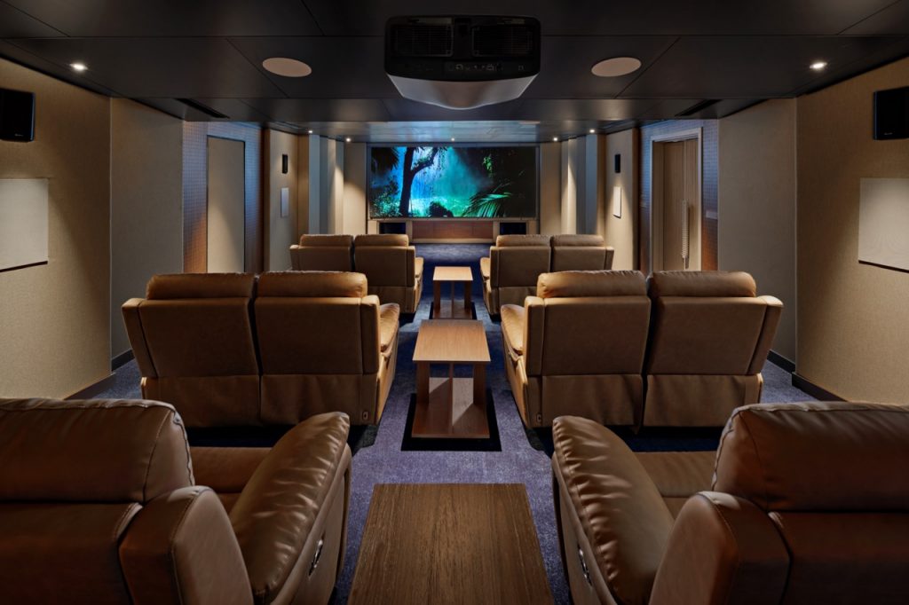 Comfortable private home theater room with leather recliners and large screen for movies.