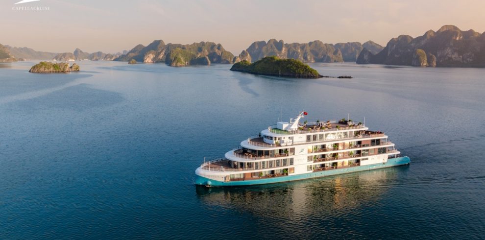 Luxury cruise boat on Ha Long Bay, Vietnam, scenic island views, tropical ocean tour.