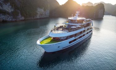 Full view of Stellar Of The Seas sailing between limestone cliffs in Lan Ha Bay, Vietnam. Join ViettrendTour for a stylish Halong Bay overnight cruise.