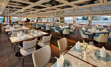 Elegant waterfront restaurant with luxurious decor and panoramic sea views.