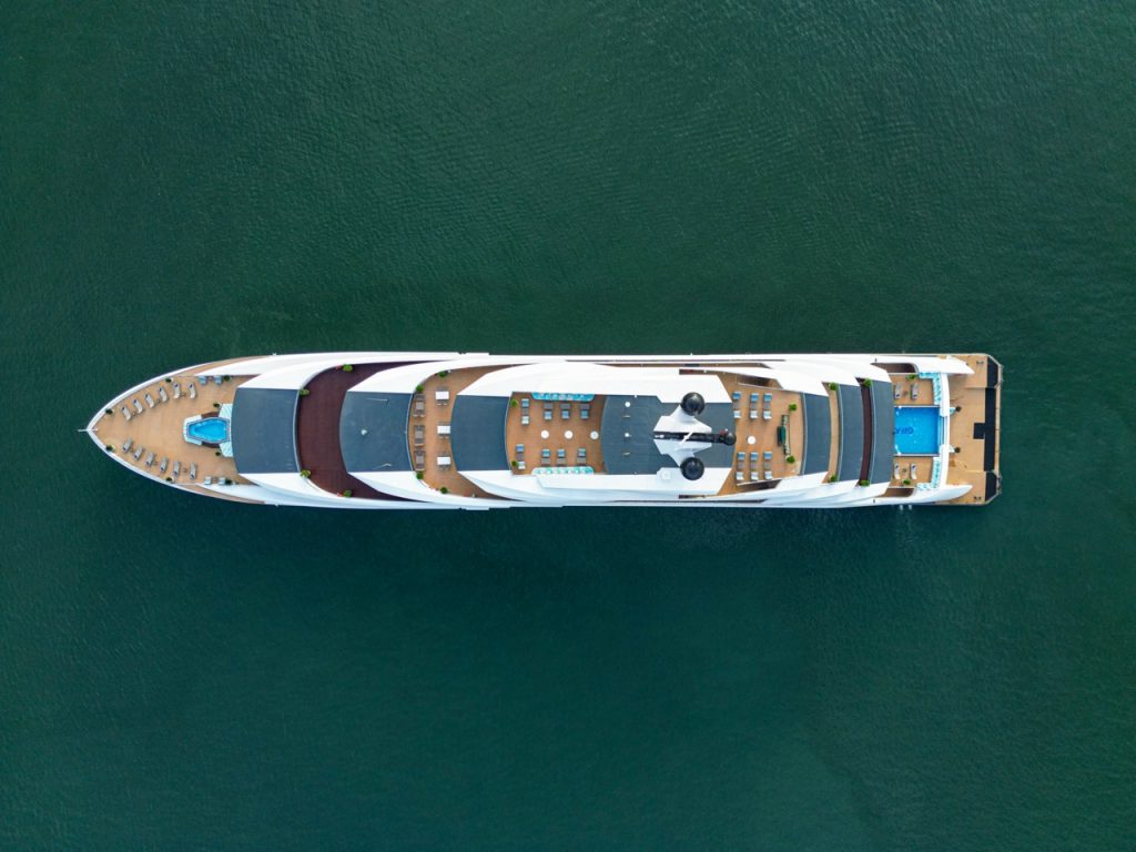 Luxury yacht cruising in emerald waters, perfect for Vietnam island tours and private charters.