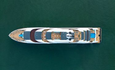 Luxury yacht cruising in emerald waters, perfect for Vietnam island tours and private charters.