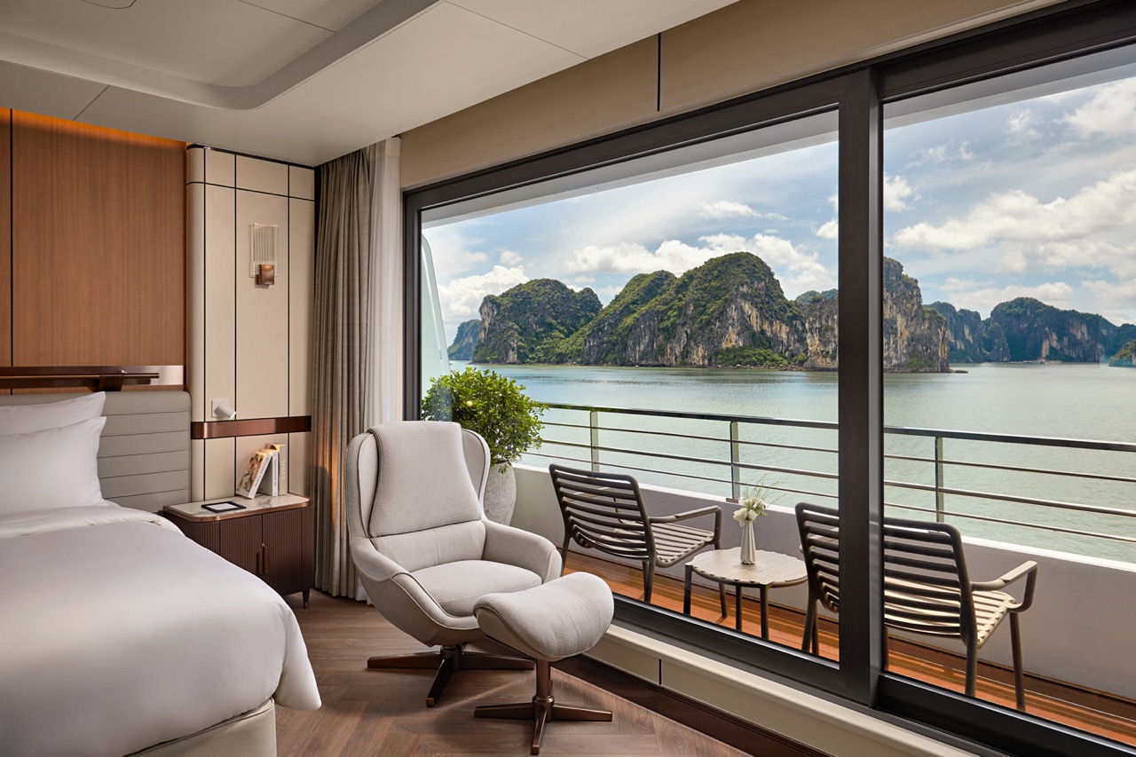 Stunning room with balcony overlooking limestone karsts and bay in Vietnam.