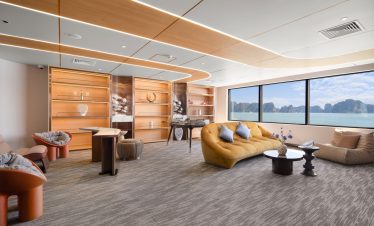 Luxurious boat lounge interior with panoramic sea views and modern decor.