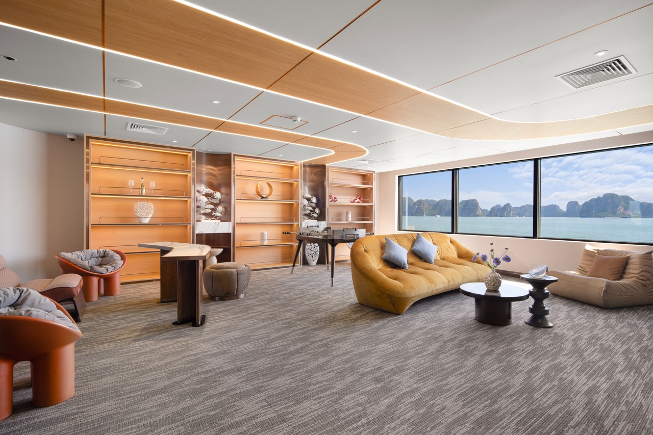 Luxurious boat lounge interior with panoramic sea views and modern decor.