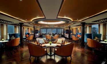 Elegant cruise lounge with luxurious seating and panoramic views.