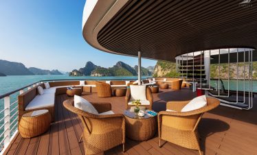 Relaxing deck on luxurious boat with scenic bay view, perfect for tropical cruise vacation SEO.