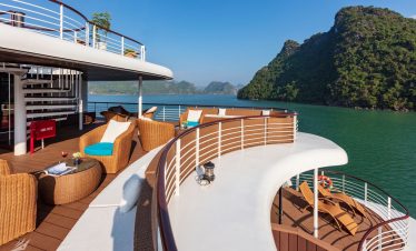 Relaxing yachting deck overlooking tropical islands and emerald waters.