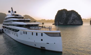 Luxurious yacht cruising in Halong Bay, Vietnam with scenic limestone islands.