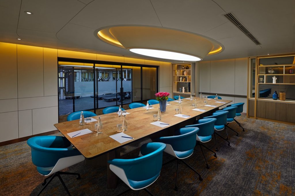 Modern corporate meeting room with conference table and stylish chairs, perfect for business events.