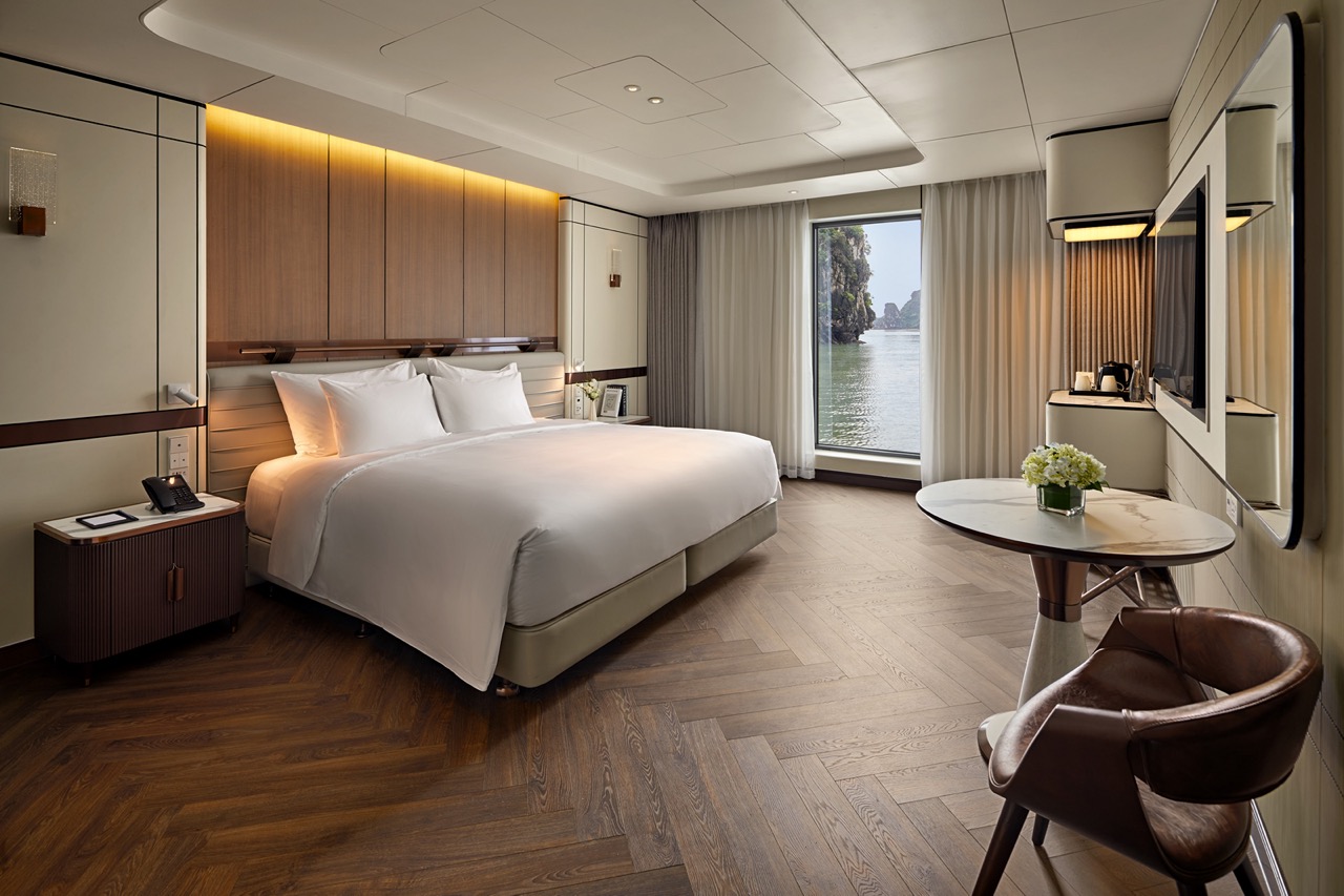 Luxurious hotel room with river view, modern decor, and comfortable bed in Vietnam.