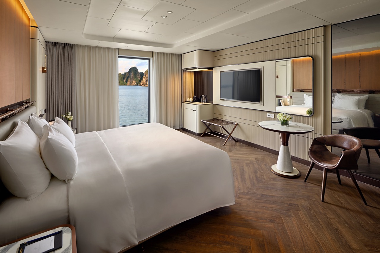 Luxury hotel room with sea view and modern amenities, comfortable king-sized bed and scenic window view.