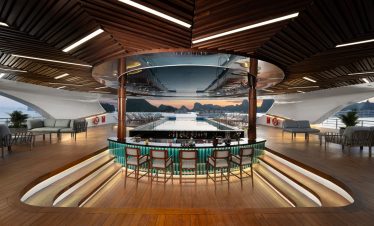 Luxury yacht indoor bar with panoramic ocean views at sunset, modern wooden design.