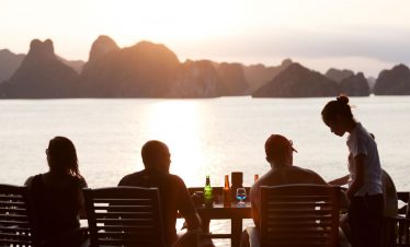 Tranquil sunset dining with scenic island views in Vietnam, perfect for luxury travel and relaxation.