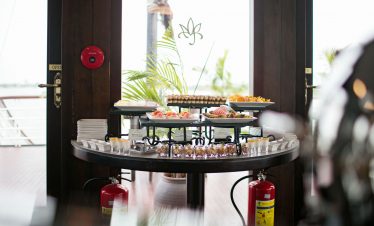 Elegant breakfast buffet with fresh desserts and tropical view at ViettrendTour.