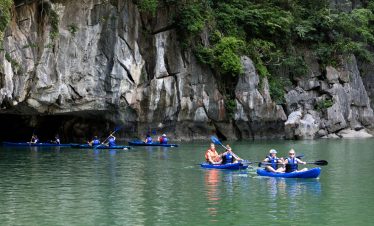 Kayaking adventure in stunning limestone caves and lush greenery in Vietnam.