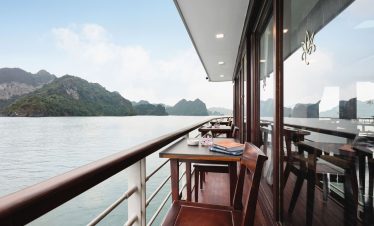 Stunning waterside balcony on a luxury cruise ship with mountain views in Vietnam.