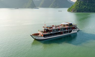 Luxury cruise on Ha Long Bay, Vietnam, with stunning limestone islands and emerald waters.