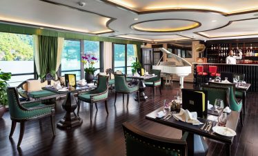Elegant lakeside restaurant interior with luxurious decor, piano, and bar, perfect for exclusive dining experiences.