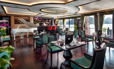 Elegant waterfront restaurant with sea view, elegant decor, and live music ambiance.