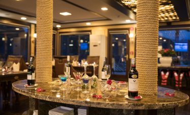 Elegant restaurant interior with romantic wine and candle setup for special occasions.