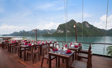 Elegant waterfront restaurant with mountain views in Vietnam, ideal for luxury dining and sightseeing.